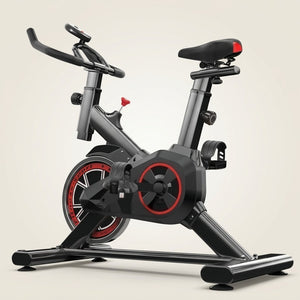 Bicicleta ergométrica spinning preta e vermelha com banco ajustável